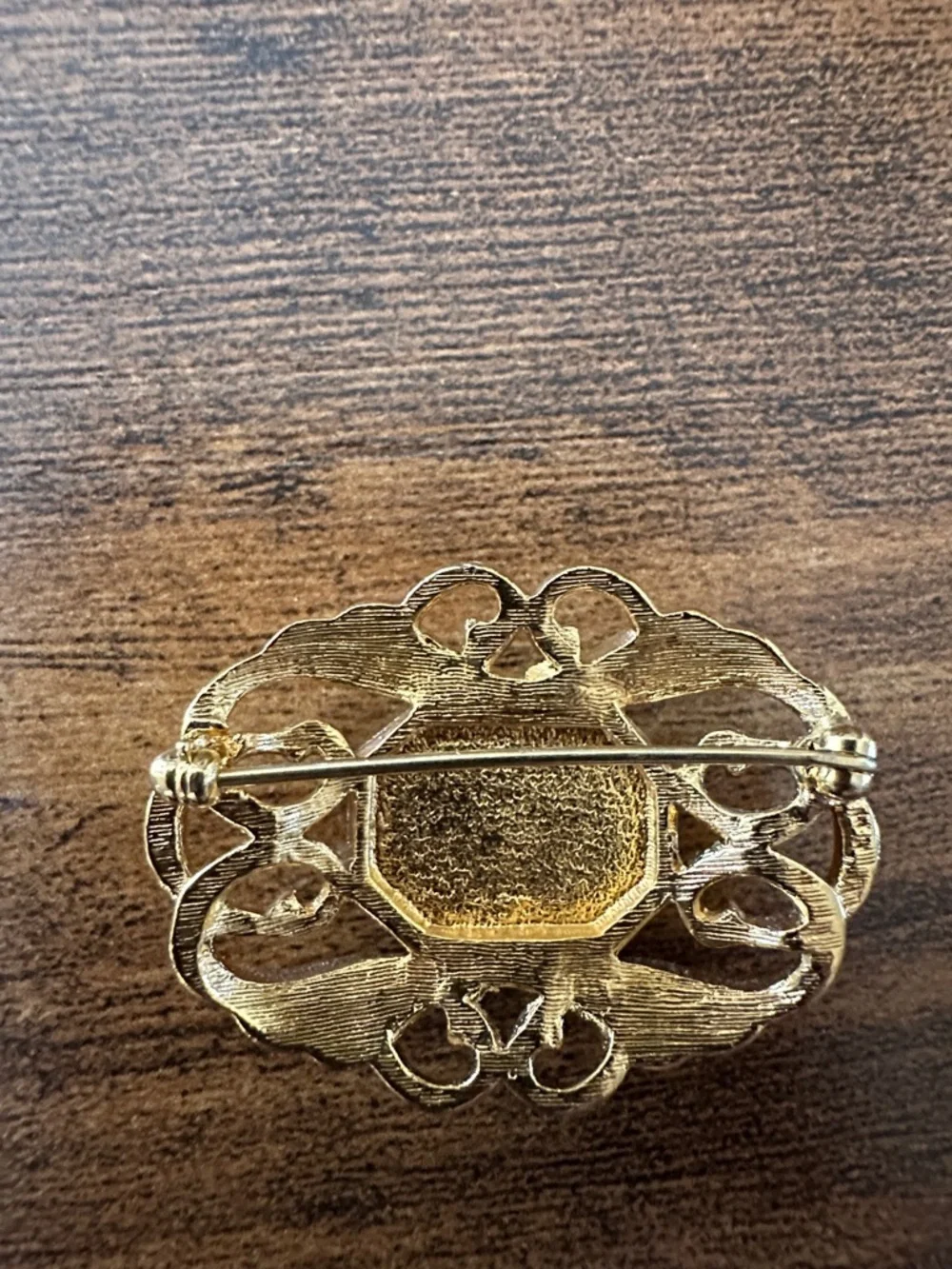 Gold-Tone Brooch with Deep Purple Center Stone